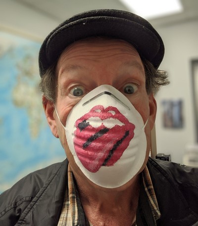 masked man with rolling stones emblem