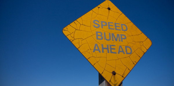 speed dump ahead sign